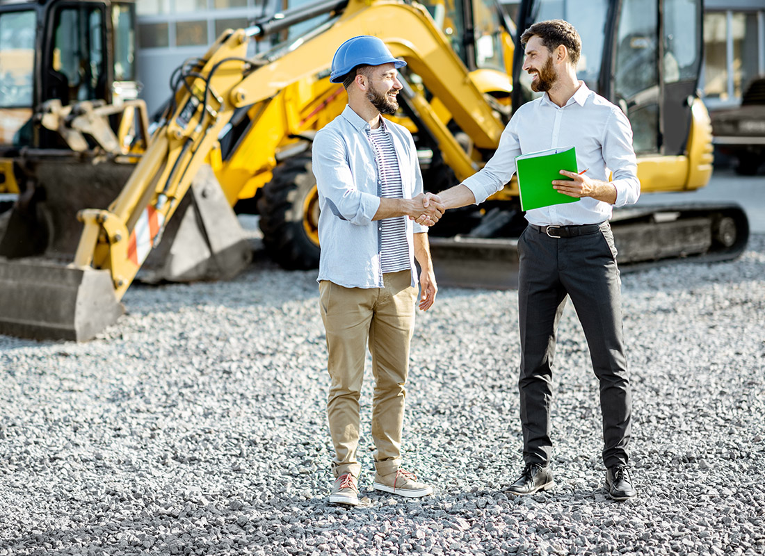 Insurance by Industry - Friendly Contractor and Worker Shake Hands at a Site